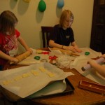 Kids rolling out the sugar cookies.